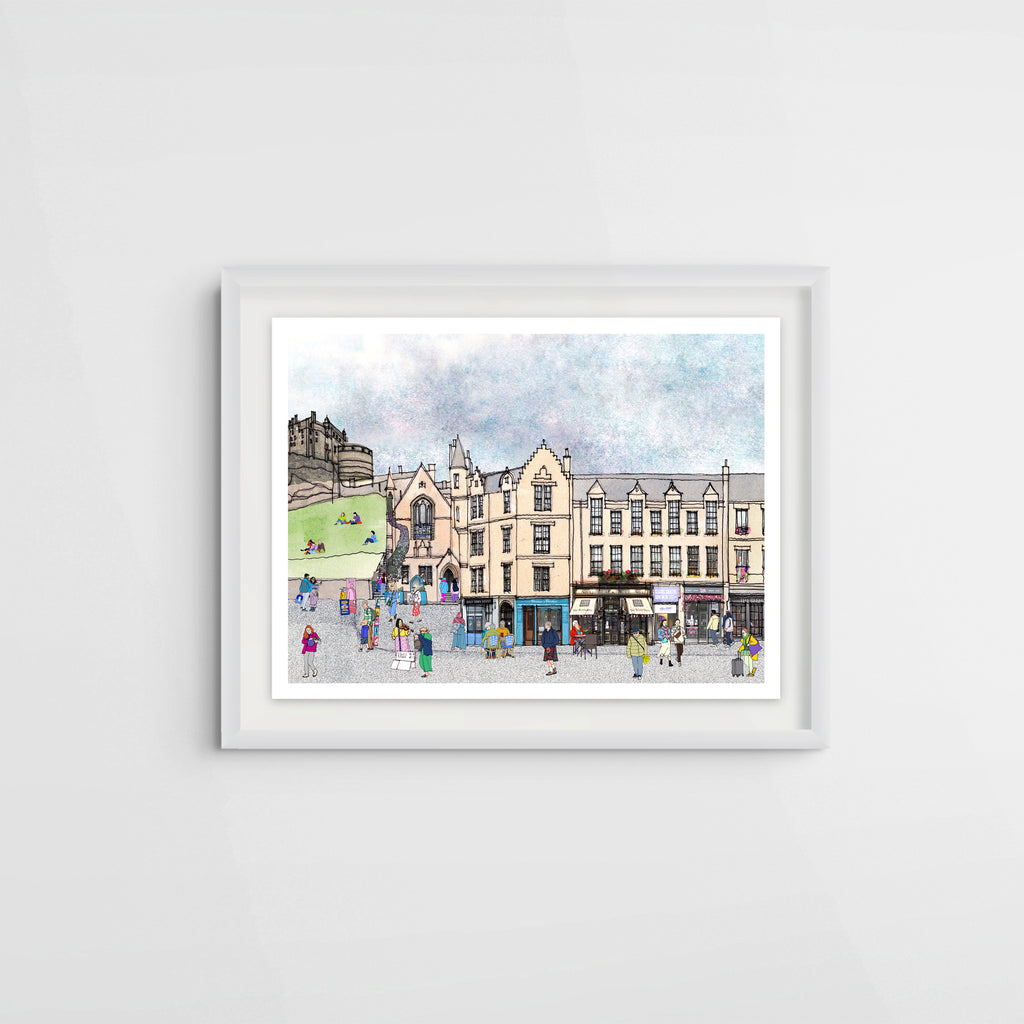 A framed watercolour art print depicting a bustling scene in Edinburgh's Grassmarket Square with historic buildings, hanging lanterns, and small figures of people, shown against a clean white wall.