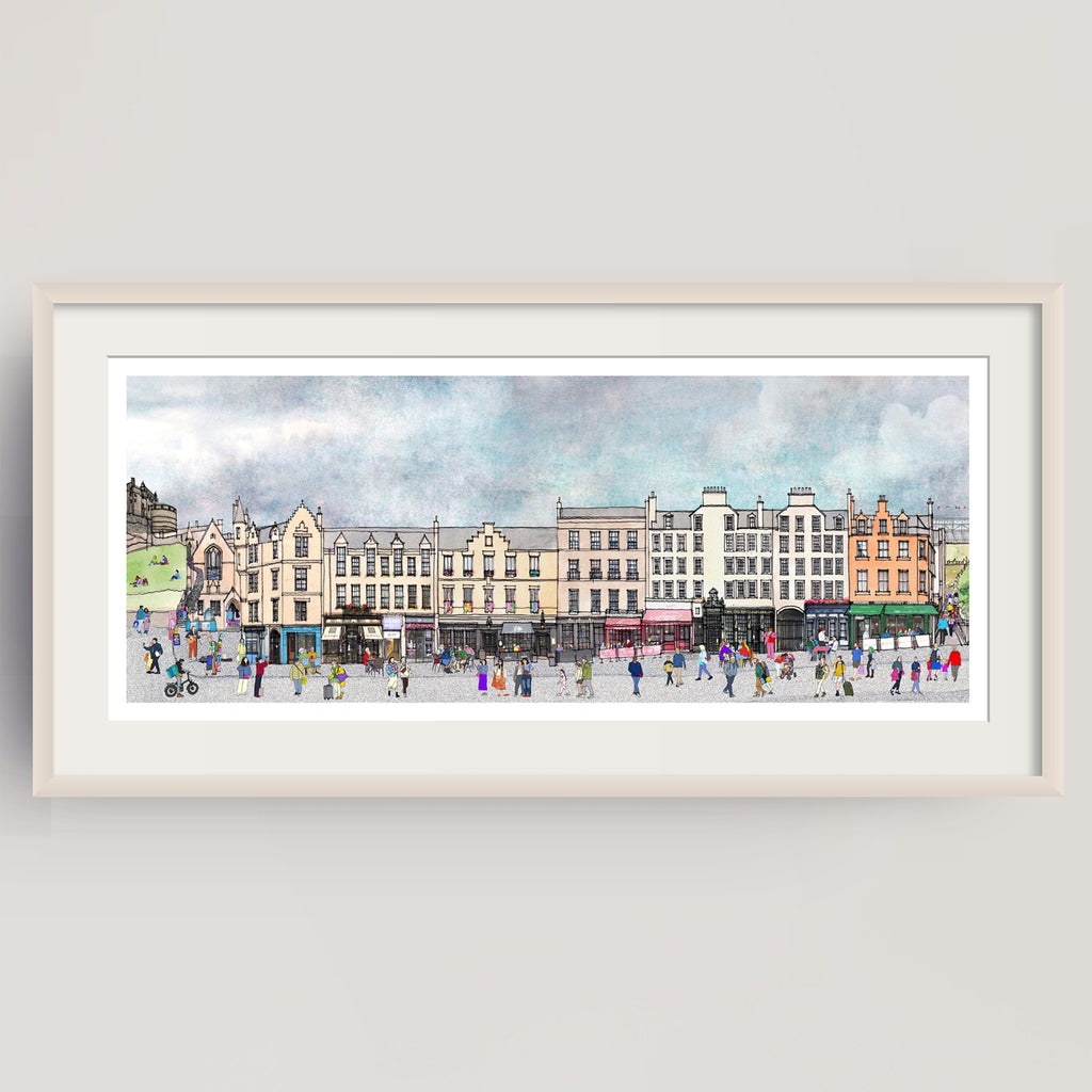 A framed panoramic watercolour print of Edinburgh's bustling Grassmarket, with historic buildings, pedestrians, and a cloudy sky, displayed against a light grey wall.