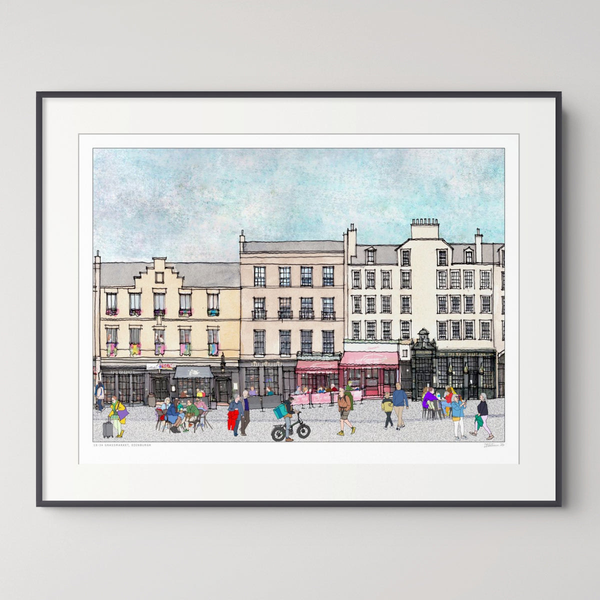 A framed art print depicting Edinburgh Grassmarket with classic buildings, pedestrians, and cyclists, presented in a white mat and a thin black frame against a light grey background.