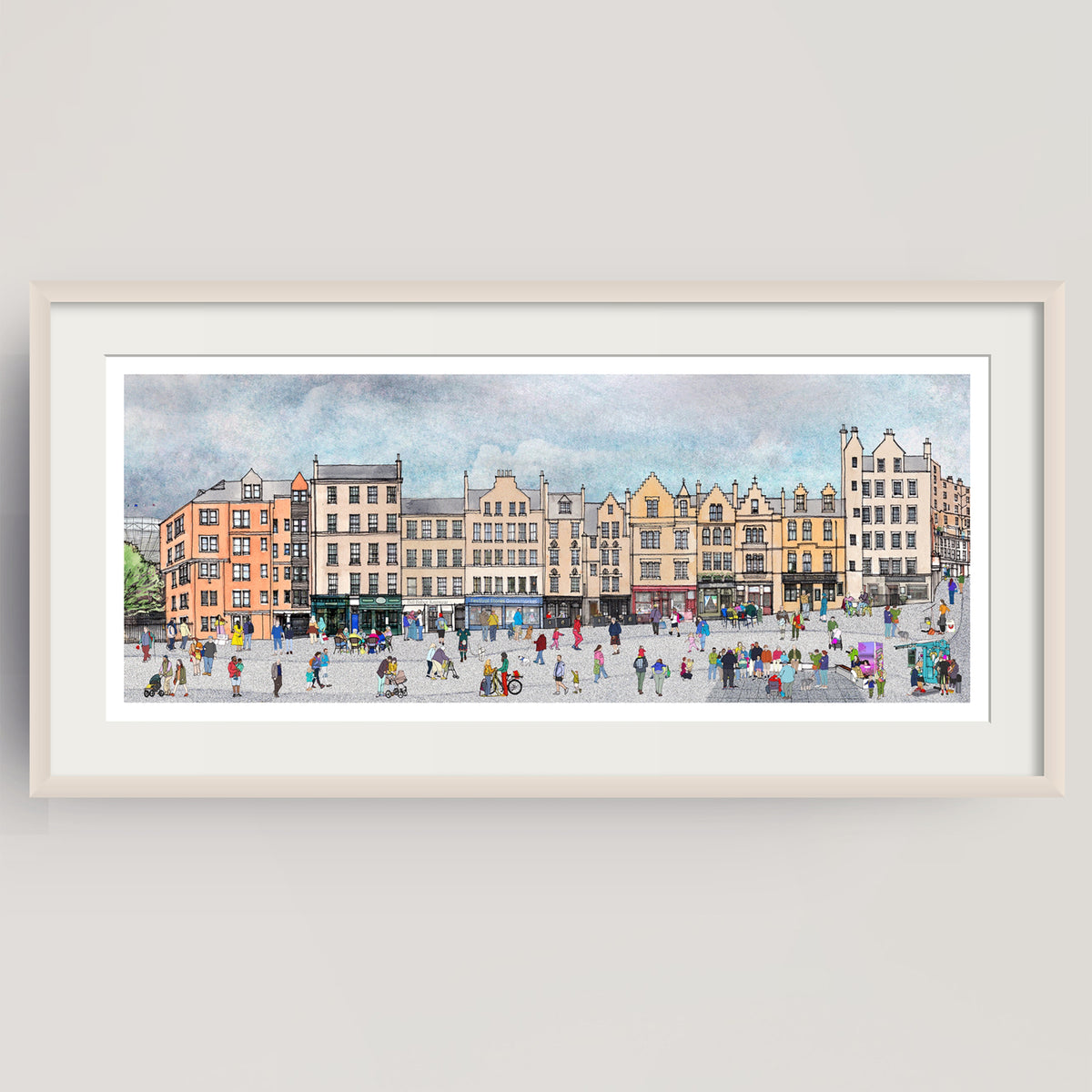 A framed panoramic watercolour print of the bustling city square of Edinburgh's Grassmarket with historic buildings and many small figures, displayed on a light grey wall.