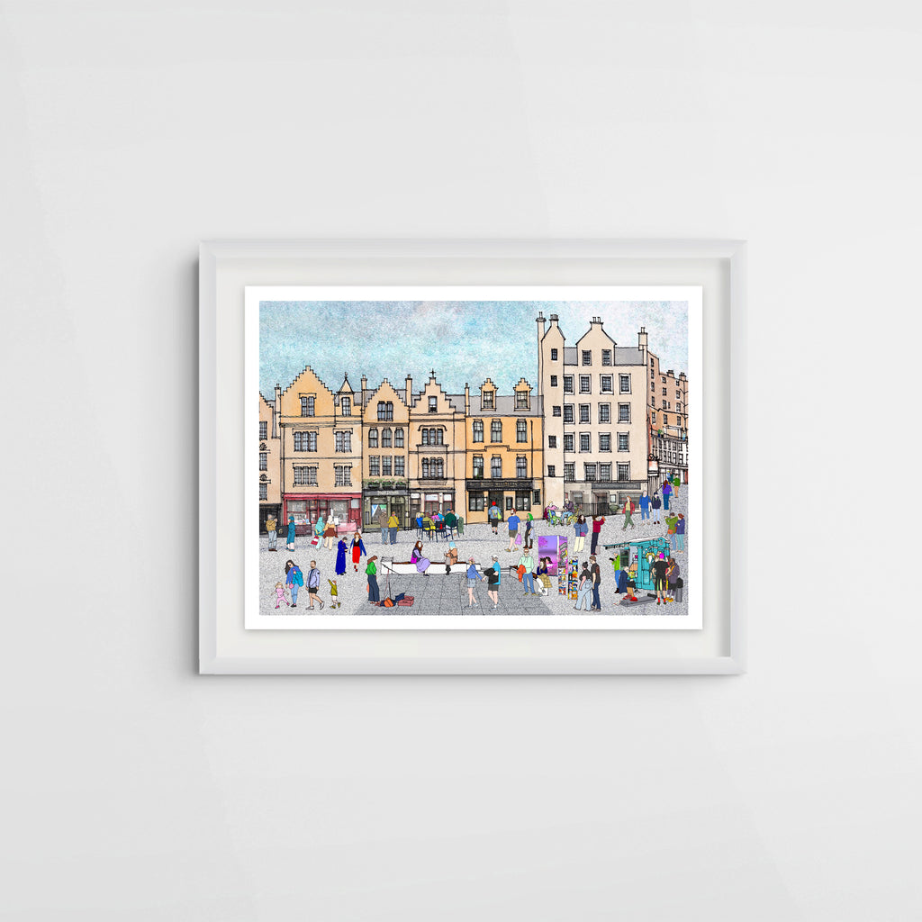 A framed art print depicting a colourful city square in Edinburgh with historic yellow buildings and small illustrated figures, shown hanging on a light grey wall.