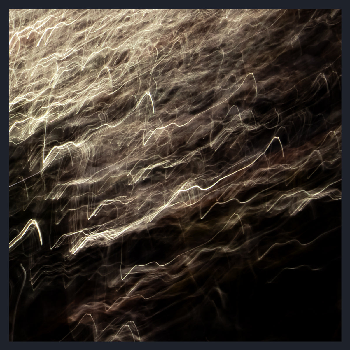 Abstract square artwork showing dark brown and black textured fields with flowing light streaks in cream, beige, and warm gold tones.