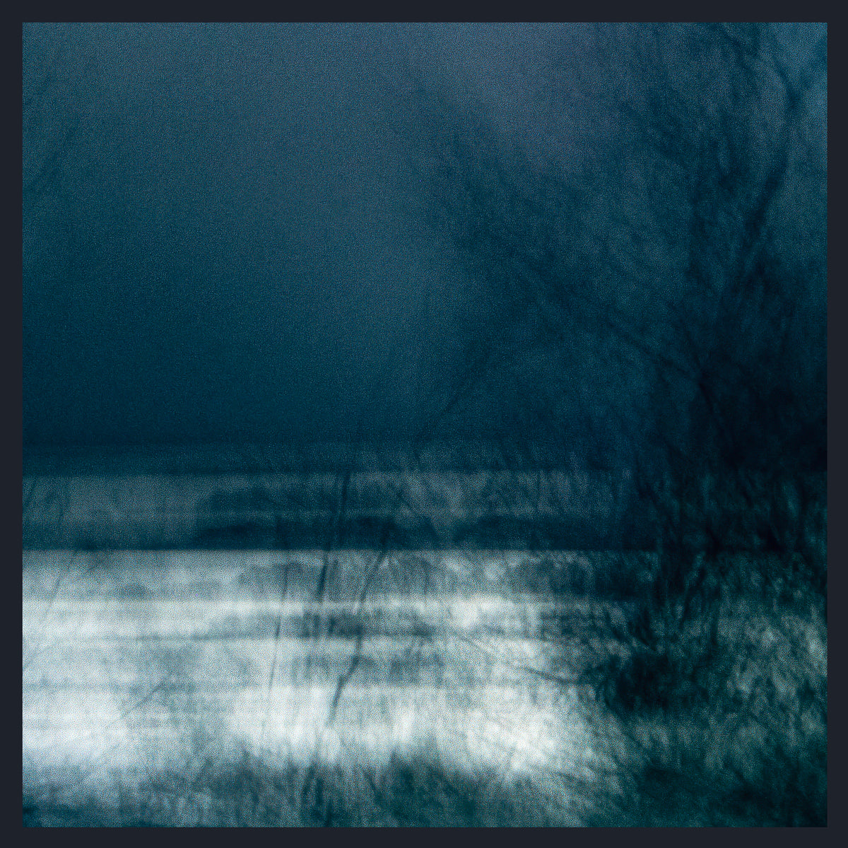 Dark blue and teal abstract landscape artwork with a bright white horizontal band across the lower middle and silhouetted tree branches across the right side.