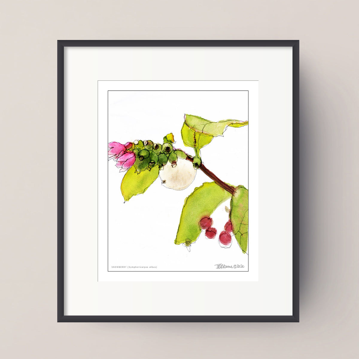 A framed botanical art print featuring a mixed-media illustration of a branch with green leaves, a pink flower, and small red berries on a white background, set in a black frame against a light beige wall.